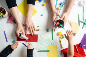 Hands doing arts and crafts.